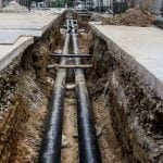 Heating and other pipeline in a hole on the street.